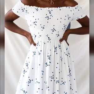 White off the shoulder dress with blue circles.